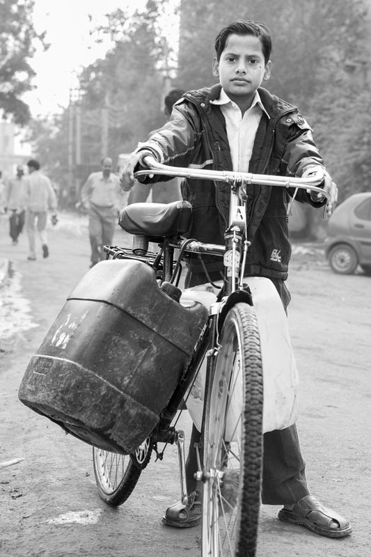 Human Right to Water in Delhi - Boy residing in a Delhi slum fetching loads of water for home from a distant source
